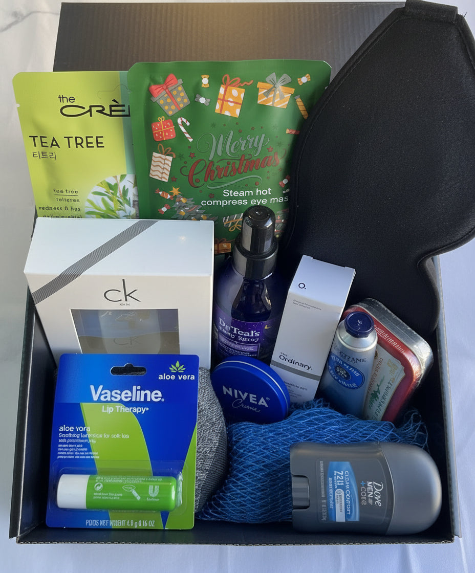 Assorted items including tea tree facial mask, steam eye mask, sleep mask and personal care products in a box.