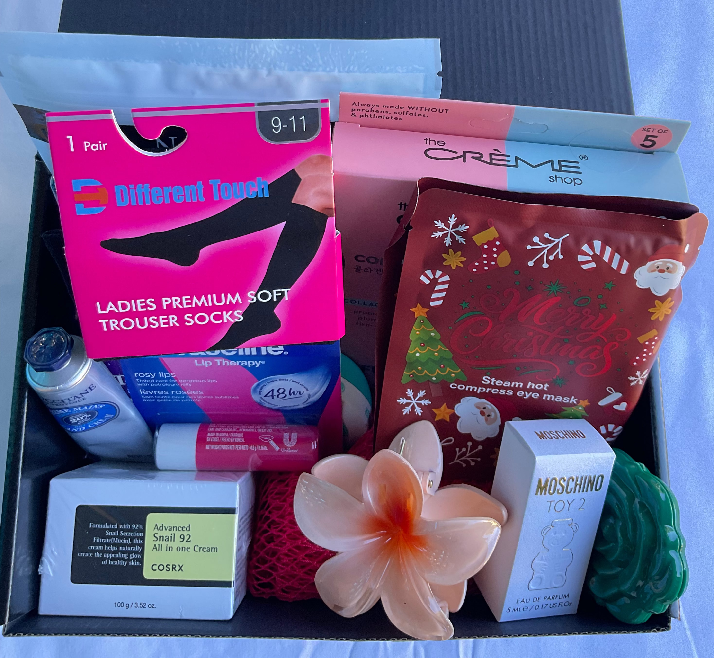 Assorted items including socks, a flower, and small boxes in a box.